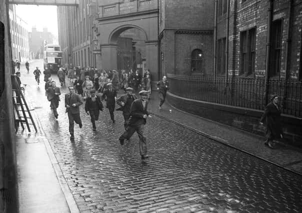 Staff run out of the Castle Mills factory at the end of their shift in November 1951. Picture: TSPL