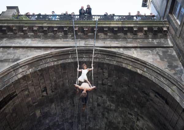 Circus artists Josa Koelbel and Bellina Sorensson perform their trapeze stunt hanging from the George IV Bridge. Picture: Jane Barlow