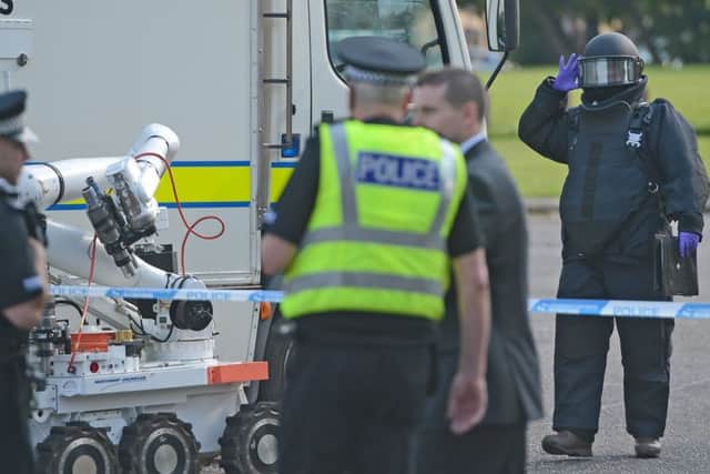 A bomb disposal team and emergency services attend the scene. Picture: Neil Hanna