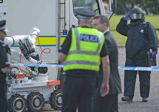 A bomb disposal team and emergency services attend the scene. Picture: Neil Hanna