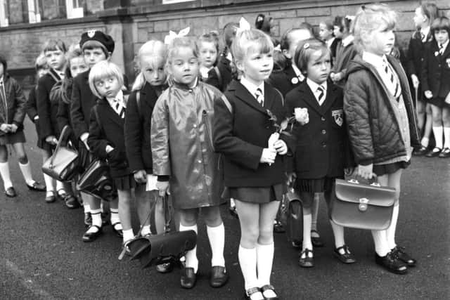 Little girls wait in the playground before their first day at Flora Stevenson primary school in Edinburgh in August 1970. Rosemary Holden in front has a rose for her new teacher.