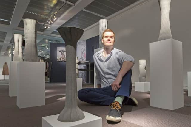 Architecture student Keith Milne with the organic concrete shapes he made using fabric moulds. Picture: Malcolm McCurrach