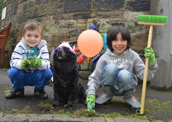 Ben and Harry Wilson with dog Lulu. Picture: Jon Savage