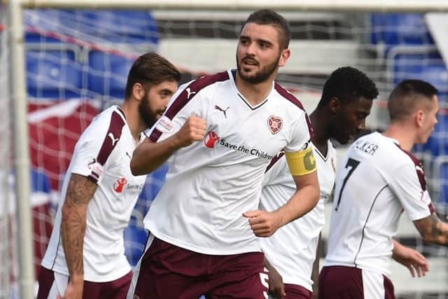 Alim Ozturk, centre, celebrates after scoring to give Hearts a two-goal lead. Picture: SNS