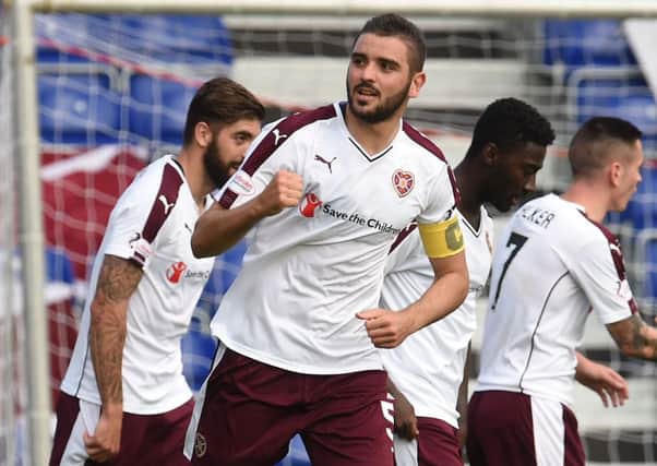 Alim Ozturk, centre, celebrates after scoring to give Hearts a two-goal lead. Picture: SNS
