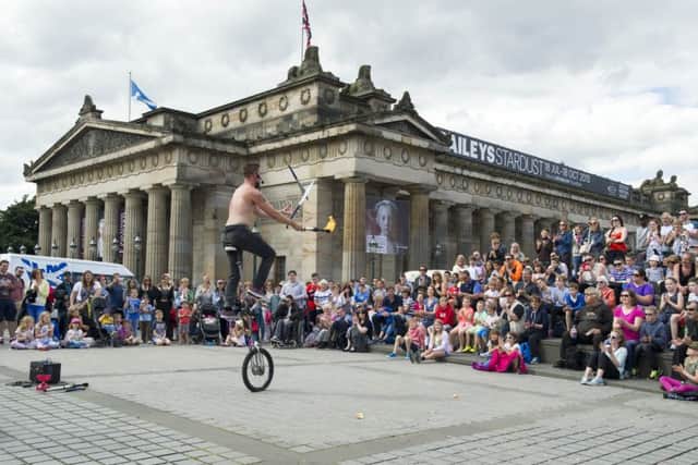 Street performer The Mighty Quinn entertains the crowds at the Mound on the opening day of this year's Festival Fringe. Picture: Ian Rutherford