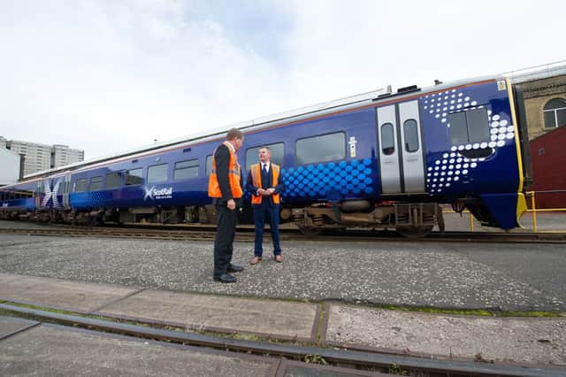 Derek Mackay, Minister for Transport and Islands and ScotRail Alliance director Phil Verster, unveil the first of 40 new-look trains . Picture: John Devlin