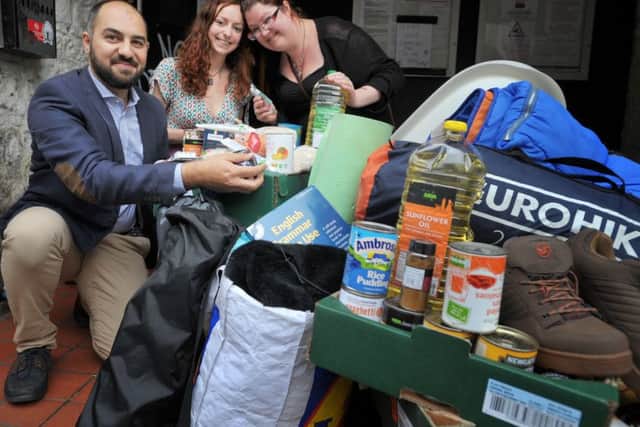 Amer Masri, Joanna McCall and Keefe McKie from CalAid with some of the items collected at the Studio 24 drop-off point. Picture: Jane Barlow
