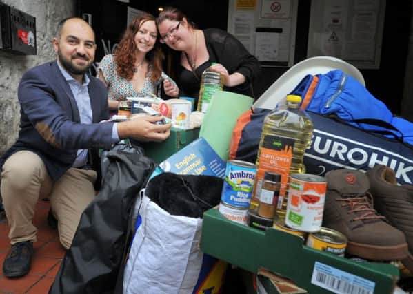 Amer Masri, Joanna McCall and Keefe McKie from CalAid with some of the items collected at the Studio 24 drop-off point. Picture: Jane Barlow