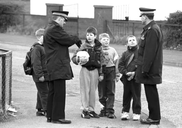 Unidentified policemen speak to children while walking their beat at Wester Hailes in Edinburgh, July 1993. Picture: TSPL