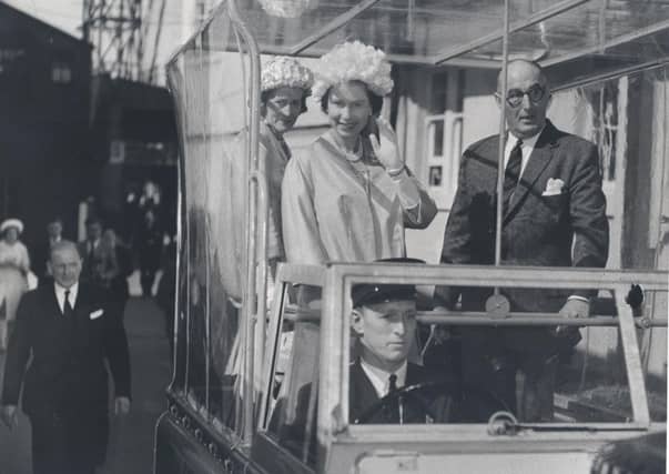 The Queen waves from a Land Rover during her tour of MacTaggart Scott, Loanhead, June 1961. Picture: Midlothian Council Local Studies
