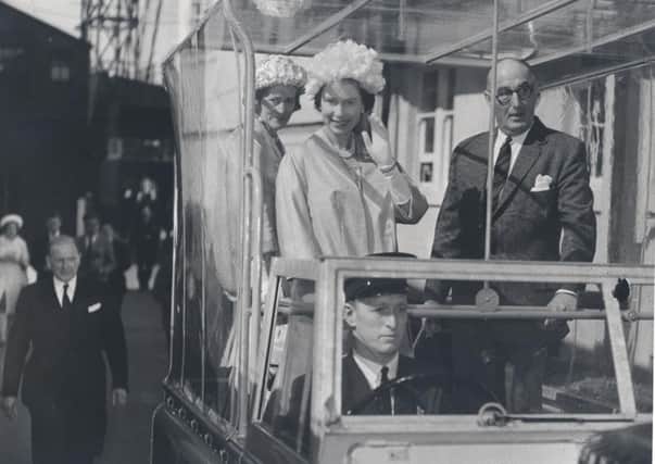 The Queen waves from a Land Rover during her tour of MacTaggart Scott, Loanhead, June 1961.  Picture: Midlothian Council Local Studies