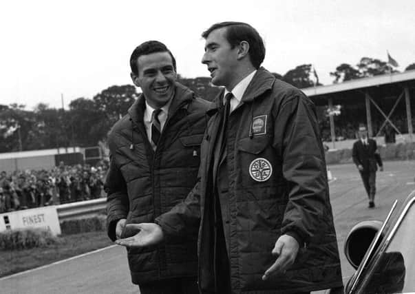 Jim Clark talks to Jackie Stewart at the Ingliston car show in 1961. Picture: TSPL