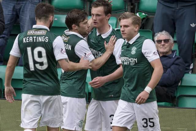 Liam Henderson, second from right, celebrates after opening the scoring for Hibernian. Picture: SNS