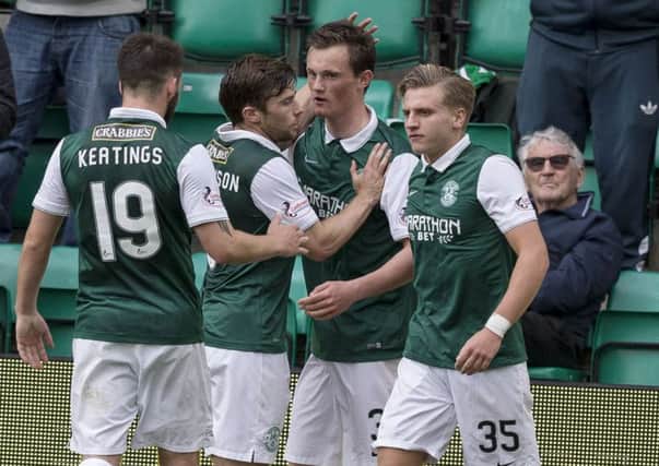 Liam Henderson, second from right, celebrates after opening the scoring for Hibernian. Picture: SNS