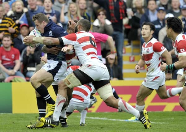 Mark Bennett bursts through the tackle of Japan captain Michael Leitch to score his second try. 
 Picture Ian Rutherford