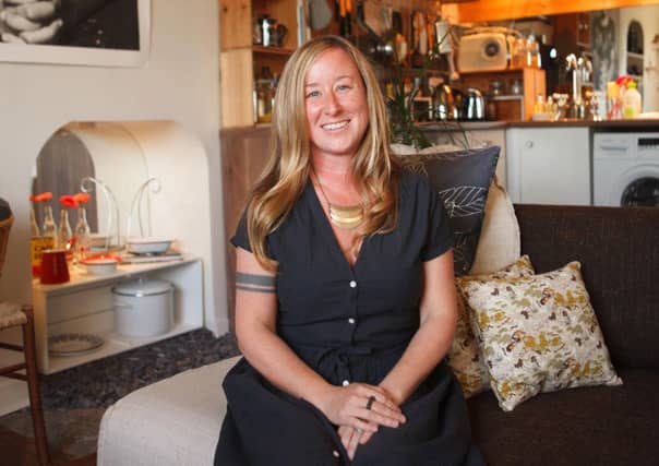 Carrie Maginn in her flat. She has been both Airbnb host and customer. Picture: Toby Williams