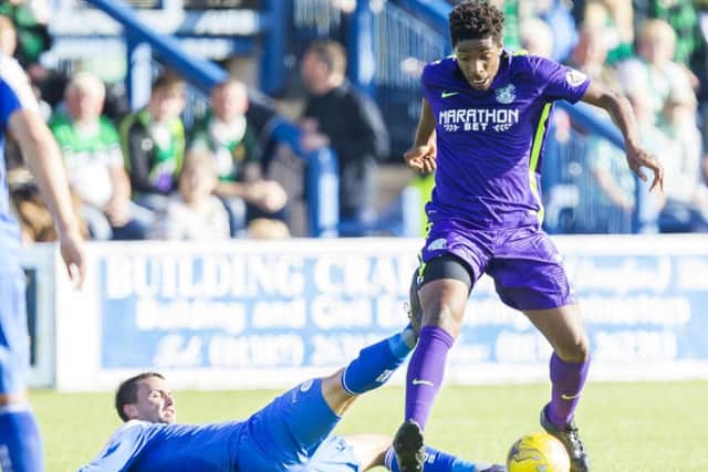 Hibernian's Dominique Malonga takes the ball away from Chris Millar. Picture: SNS