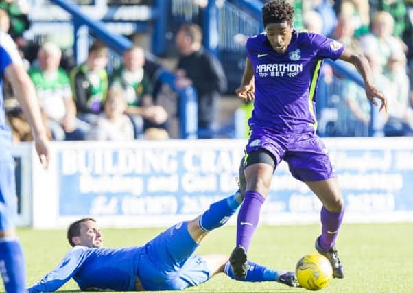 Hibernian's Dominique Malonga takes the ball away from Chris Millar. Picture: SNS