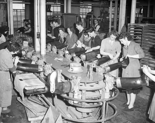 Factory workers making Wellington boots in 1951. Picture: TSPL
