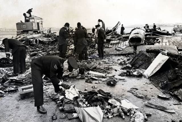 Emergency crews examine the wreckage of the plane. Picture: Daily Mail