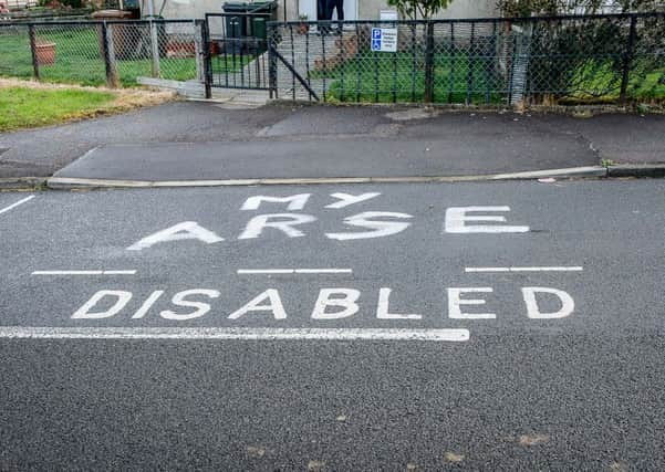 Vandals have painted a derogatory slogan on the disabled parking space outside the home of Alexander Begg