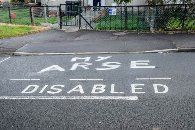 Vandals have painted a derogatory slogan on the disabled parking space outside the home of Alexander Begg