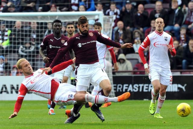 Hearts Juanma Delgadois tackled by Ross County's Andrew Davies during Saturday's match. Picture: Lisa Ferguson