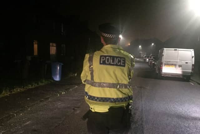 Police guard the scene at Mayfield Drive after the stabbing. Pic: Lisa Ferguson