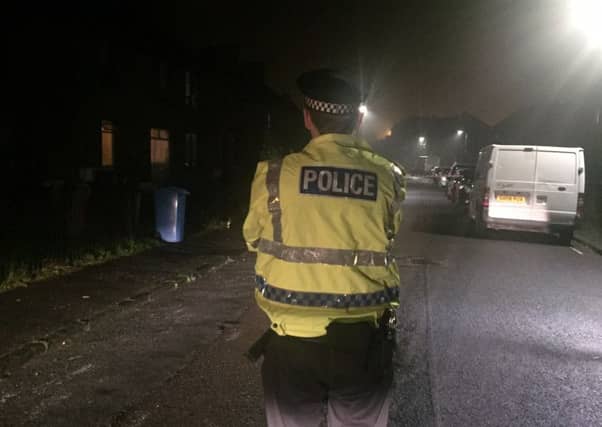 Police guard the scene at Mayfield Drive after the stabbing. Pic: Lisa Ferguson