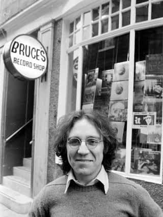 A view of Bruce Findlay standing outside his record shop in Edinburgh