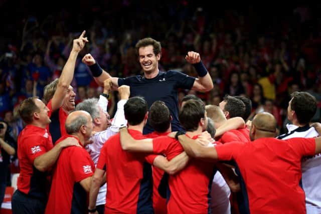 Great Britain's Andy Murray is mobbed by his team-mates after beating David Goffin to win the Davis Cup Final. Picture: PA