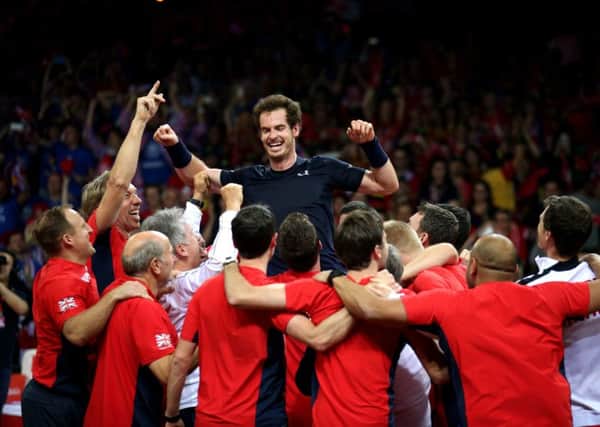 Great Britain's Andy Murray is mobbed by his team-mates after beating David Goffin to win the Davis Cup Final. Picture: PA