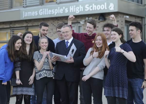 Headteacher 
Donald Macdonald celebrates the news with some S6 pupils. Picture: Neil Hanna