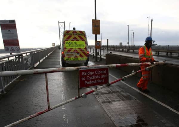 A road worker closes a gate on the Forth Road Bridge. Picture PA