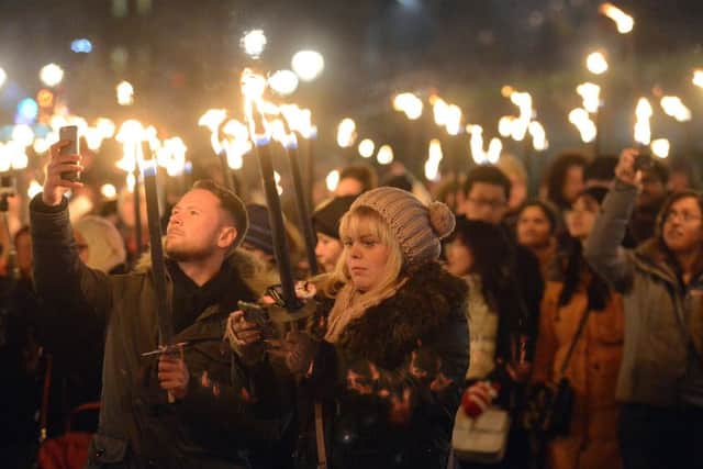 Revellers join in last years Torchlight Procession in part of Edinburghs Hogmanay celebrations. Picture: Neil Hanna