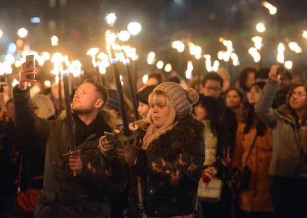 Revellers join in last years Torchlight Procession in part of Edinburghs Hogmanay celebrations. Picture: Neil Hanna