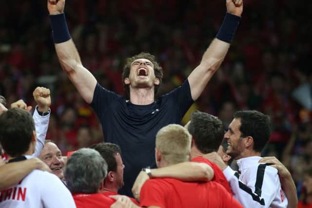 Andy Murray is hoisted up by his teammates as they celebrates winning the Davis Cup. Pic: PA
