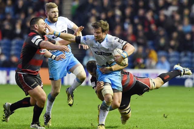 Glasgow's Peter Horne attempts to escape the attentions of Edinburgh's Shane Sutherland. Picture: SNS
