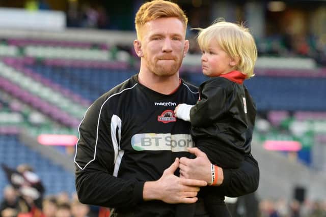 An emotional Roddy Grant, with daughter Reeva, places the match ball. The popular flanker was forced to retire earlier this week. Picture: SNS Group