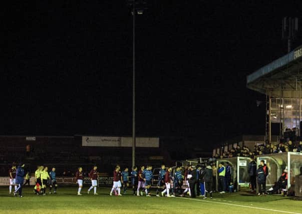 The players trudge off at Station Park after the lights went out. Pic: SNS