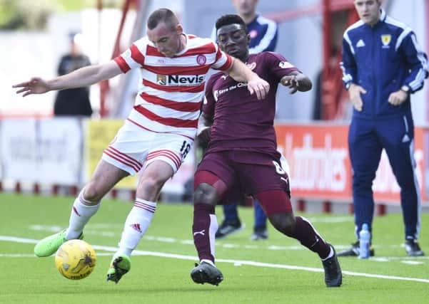 Prince Buaben challenges Darian MacKinnon during the explosive 3-2 defeat at Hamilton in August