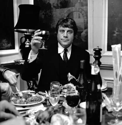 Oliver Reed toasts the photographer as he enjoys dinner in Edinburgh in 1971.Picture: TSPL