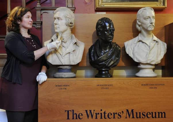 Gillian Findlay with busts of Burns, Scott and Stevenson at the Writers' Museum. Picture: Neil Hanna