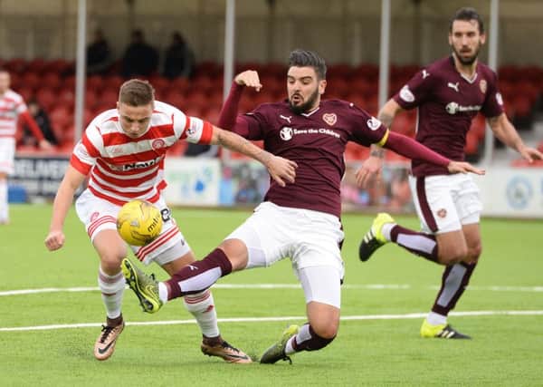 Hearts captain Alim Ozturk snuffs out another Hamilton attack. Pic: SNS