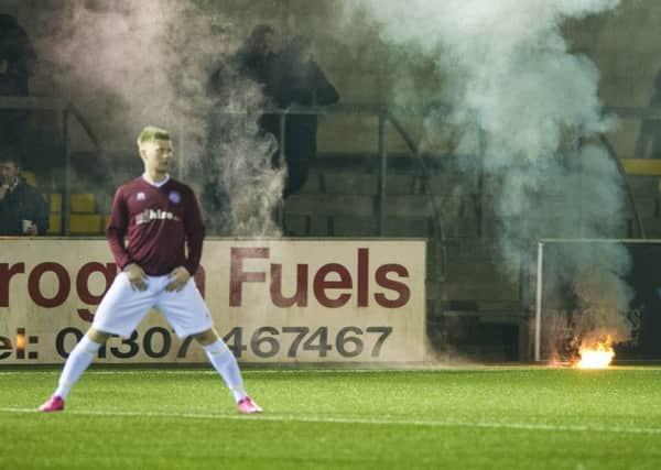 Fans threw flares onto the Station Park pitch last week