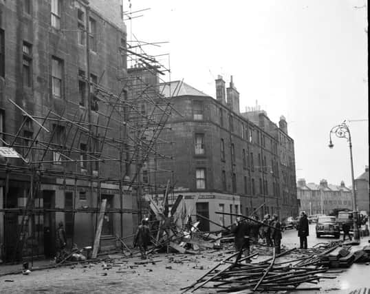 Scaffolding is scattered all across Graham Street in Leith after being blown down in 1962. Picture: TSPL