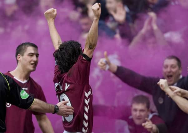Rudi Skacel, left, and Paul Hartley celebrate in front of the fans