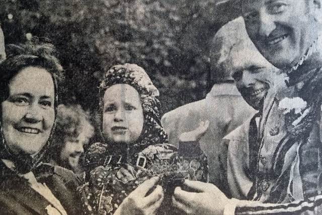 The cutting from the Evening News of 24th July 1974 showing Neil Wilson, aged 22 months, being presented with the sod which had hit him in the face after the firest ceremonial cutting of the turf had struck him when Turf Cutter George Innes had tossed it over his shoulder.  George presented the turf to Neil and his mother Isabel at the ceremony at the Musselburgh Riding of the Marches.