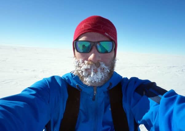 Luke Robertson at the South Pole after his trek across Antarctica. Picture: comp